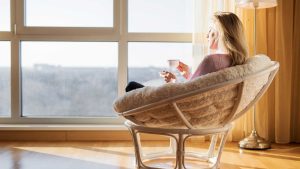 woman sitting in front of a window enjoy a cup of tea