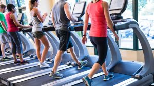 men and women walking on treadmills 10 Way to reduce stress naturally